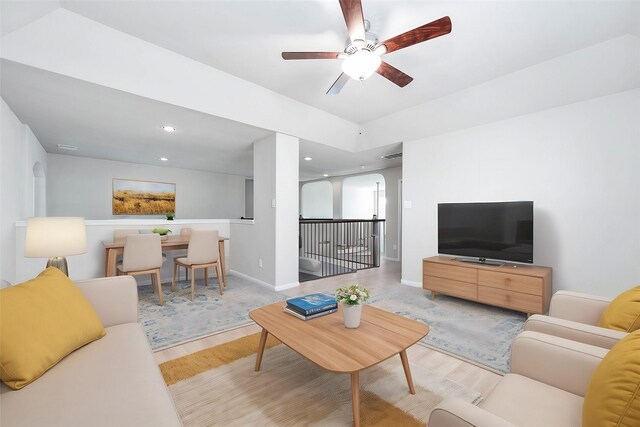 living room with light wood-type flooring and ceiling fan