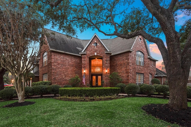 16403 Agusta Ct, Spring, TX 77379 - tudor home featuring brick siding, a yard, and roof with shingles