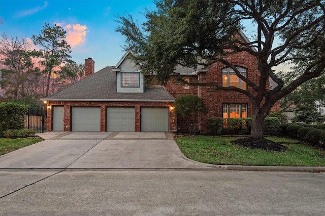 view of front of house with a yard and a garage