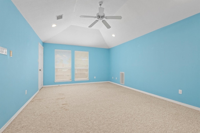 unfurnished room featuring ceiling fan, lofted ceiling, and carpet floors