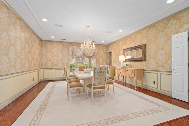 dining room with ornamental molding and a chandelier