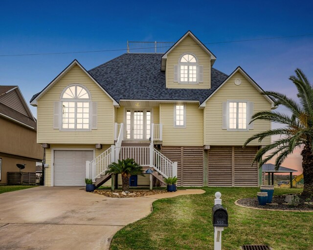 view of front of house featuring a garage and a yard