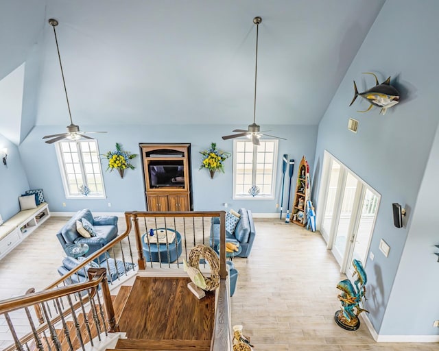 interior space with high vaulted ceiling, plenty of natural light, and light hardwood / wood-style flooring