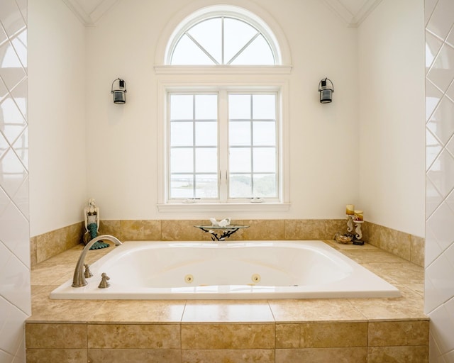 bathroom with a relaxing tiled tub, a wealth of natural light, and crown molding