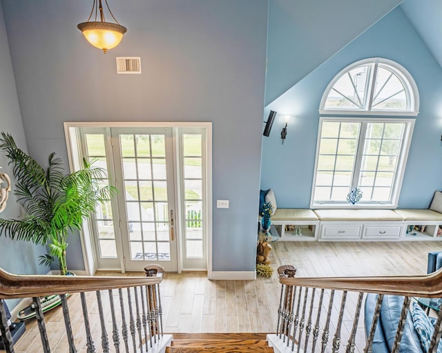 foyer entrance featuring lofted ceiling and light hardwood / wood-style floors