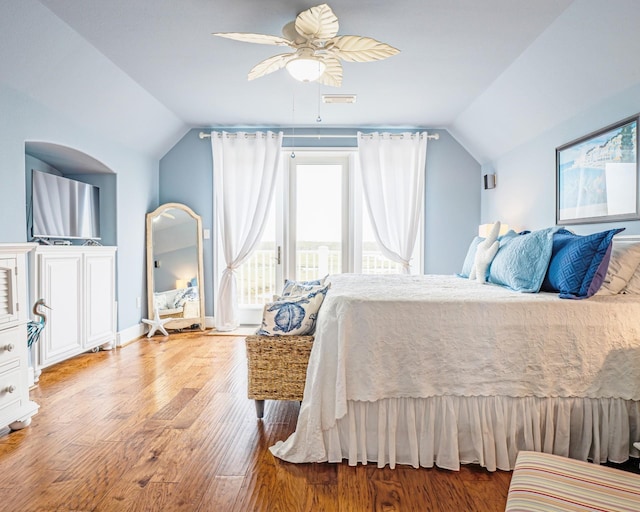 bedroom with ceiling fan, hardwood / wood-style flooring, and lofted ceiling