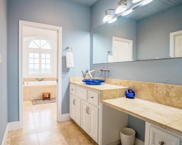 bathroom featuring vanity, tile patterned flooring, and a relaxing tiled tub