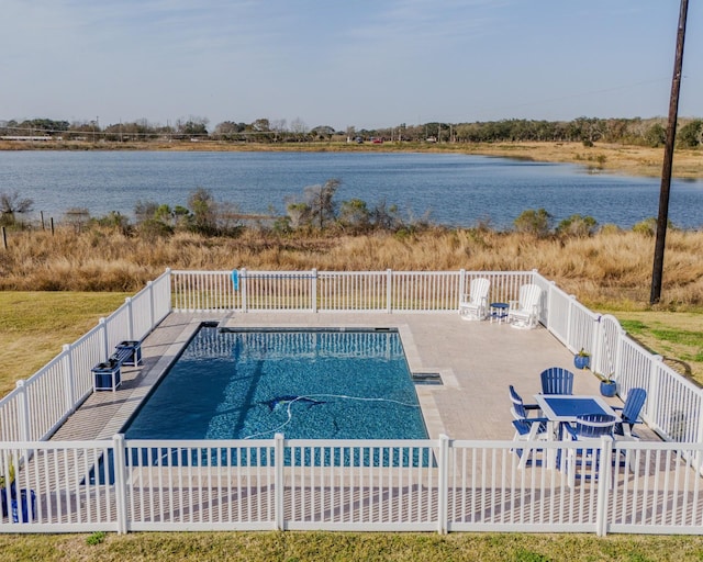 view of pool with a water view and a patio