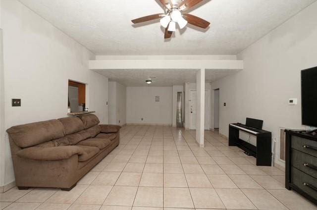 living room featuring ceiling fan and light tile patterned floors