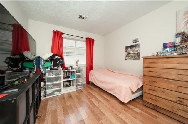 bedroom with hardwood / wood-style floors