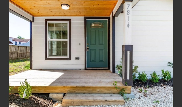 view of exterior entry with a porch