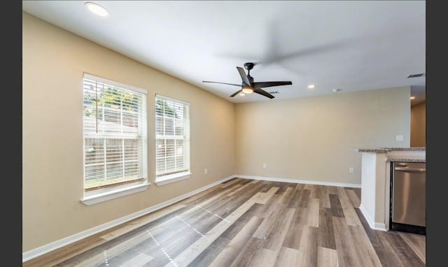 unfurnished living room with ceiling fan and wood-type flooring