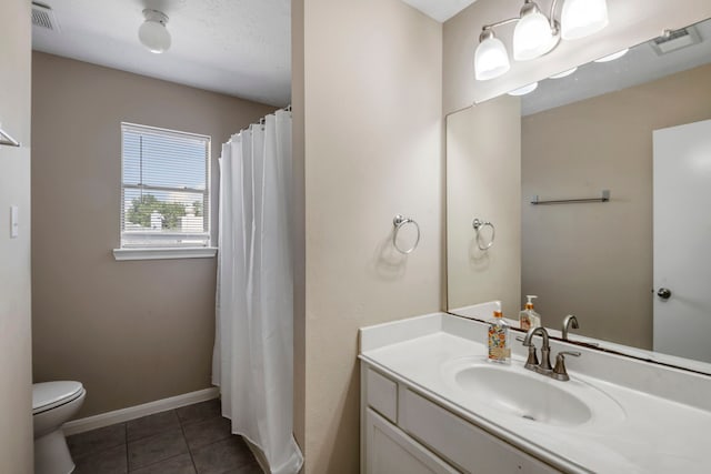 bathroom featuring toilet, vanity, and tile patterned floors