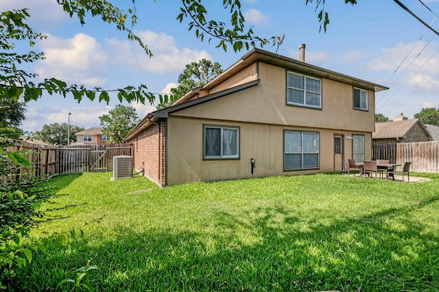 back of property featuring a yard and central AC unit