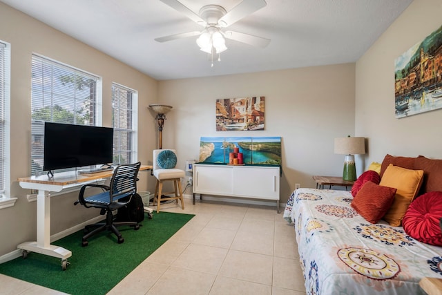 tiled bedroom featuring ceiling fan