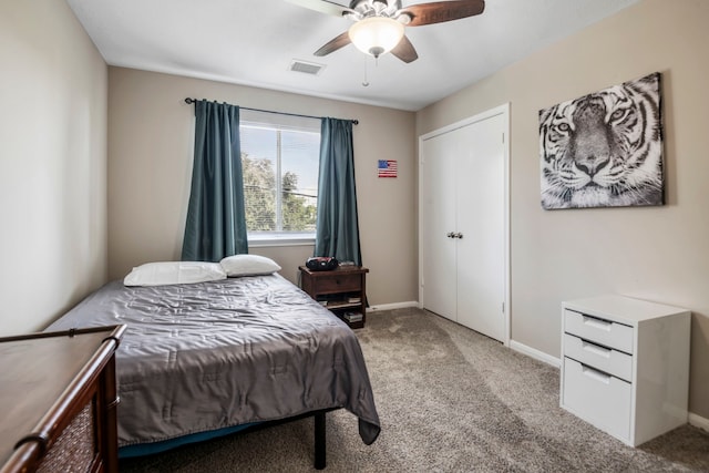 carpeted bedroom featuring ceiling fan and a closet