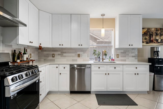 kitchen with backsplash, wall chimney exhaust hood, stainless steel appliances, sink, and white cabinets