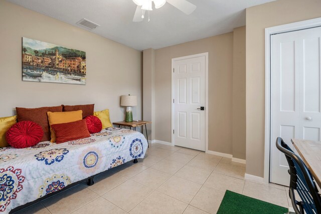 bedroom with ceiling fan and light tile patterned flooring