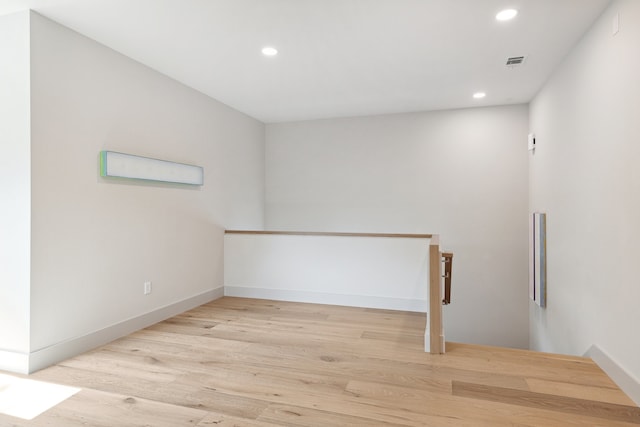 empty room with light hardwood / wood-style flooring