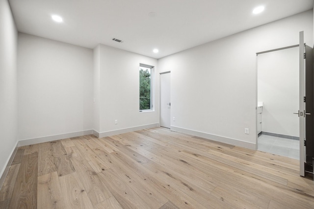 spare room featuring light hardwood / wood-style floors