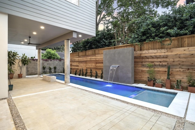 view of swimming pool with a patio area, ceiling fan, pool water feature, and a jacuzzi