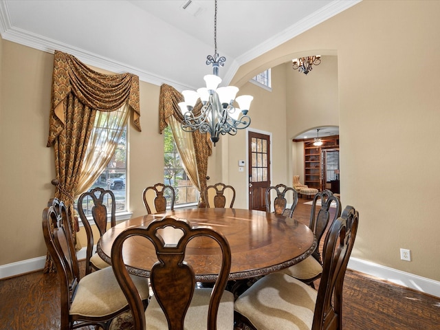 dining area with a notable chandelier, crown molding, and plenty of natural light