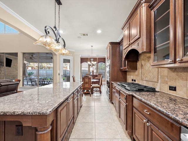 kitchen with a kitchen island, crown molding, and hanging light fixtures