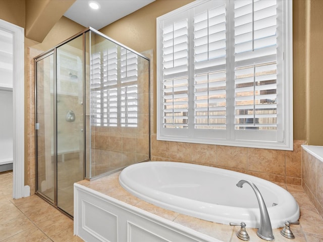 bathroom featuring tile patterned flooring and plus walk in shower