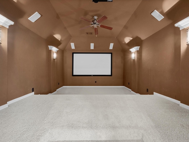 home theater with ceiling fan, vaulted ceiling, light carpet, and ornate columns