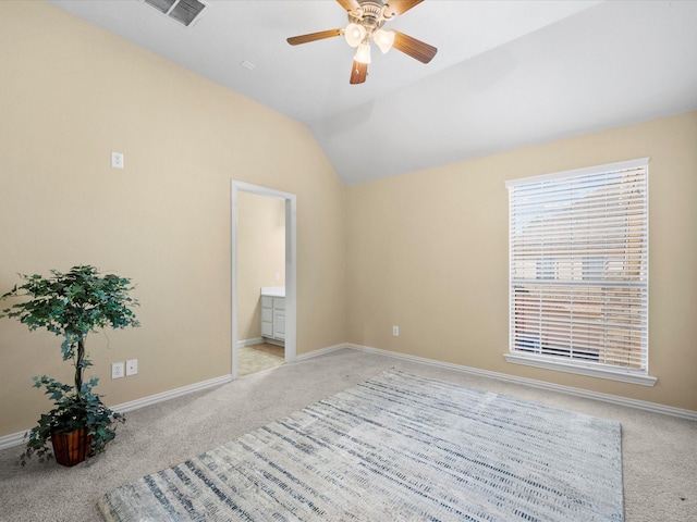 carpeted spare room featuring ceiling fan and lofted ceiling