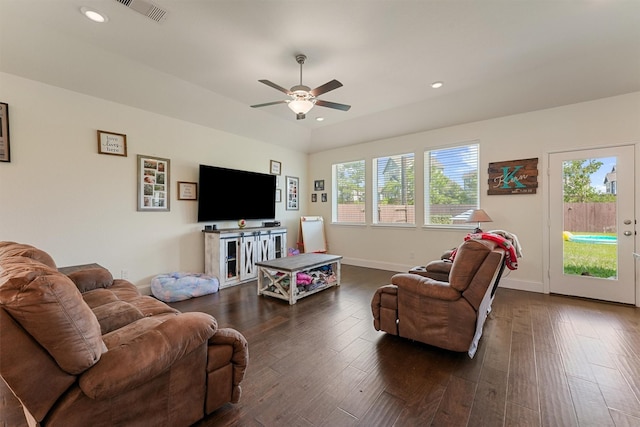 living room with ceiling fan and dark wood-type flooring