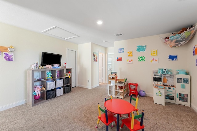 recreation room featuring light colored carpet