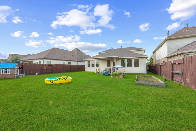 back of house with a yard