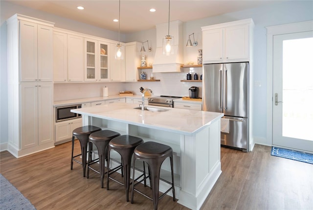 kitchen with white cabinets, high end fridge, and built in microwave