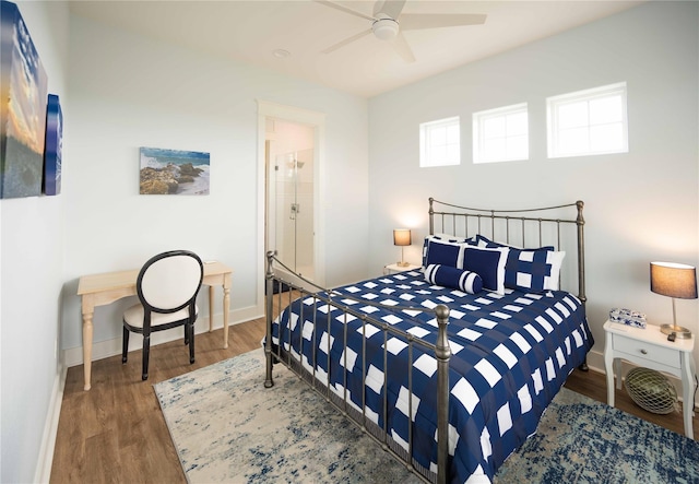 bedroom with ceiling fan, ensuite bathroom, and dark hardwood / wood-style floors