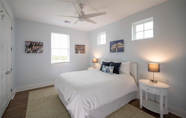 bedroom with dark hardwood / wood-style flooring and ceiling fan