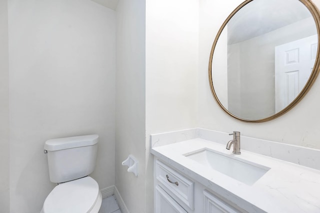 bathroom featuring tile patterned floors, vanity, and toilet