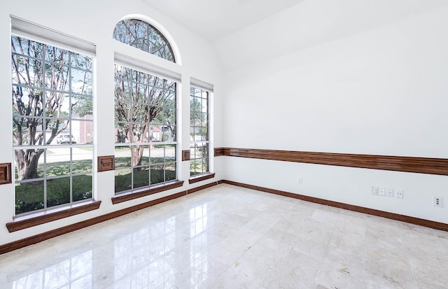 empty room featuring lofted ceiling