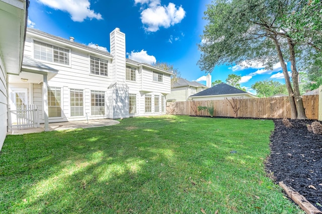 rear view of property with a patio area and a yard