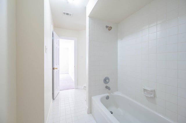 bathroom with tile patterned floors and tiled shower / bath