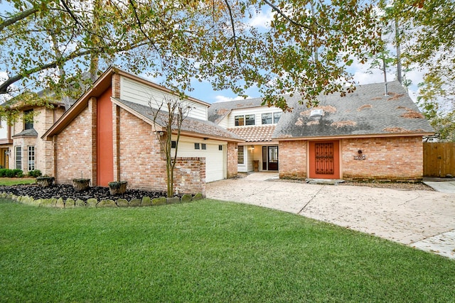 view of property featuring a garage and a front yard