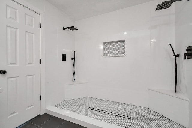 bathroom featuring tile patterned floors and a tile shower