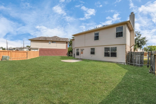 rear view of house with a lawn