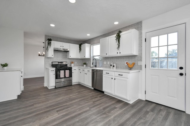 kitchen featuring white cabinetry, sink, dark hardwood / wood-style flooring, decorative backsplash, and appliances with stainless steel finishes