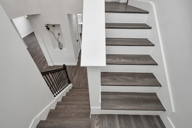 stairway with hardwood / wood-style flooring