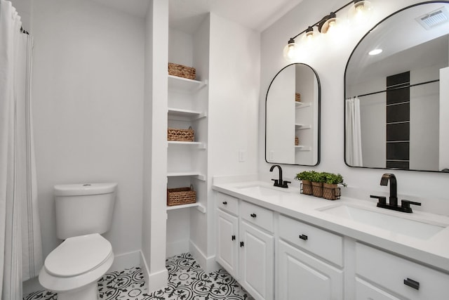 bathroom featuring tile patterned flooring, vanity, and toilet