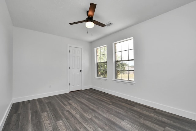 spare room with ceiling fan and dark hardwood / wood-style floors