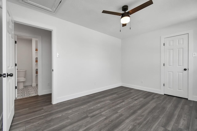 spare room featuring ceiling fan and dark wood-type flooring