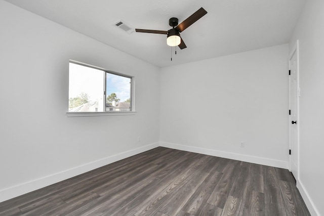 empty room featuring ceiling fan and dark wood-type flooring