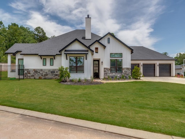 view of front of home featuring a front yard and a garage